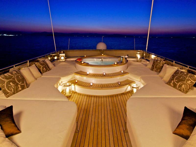 Luxurious superyacht deck at night with jacuzzi